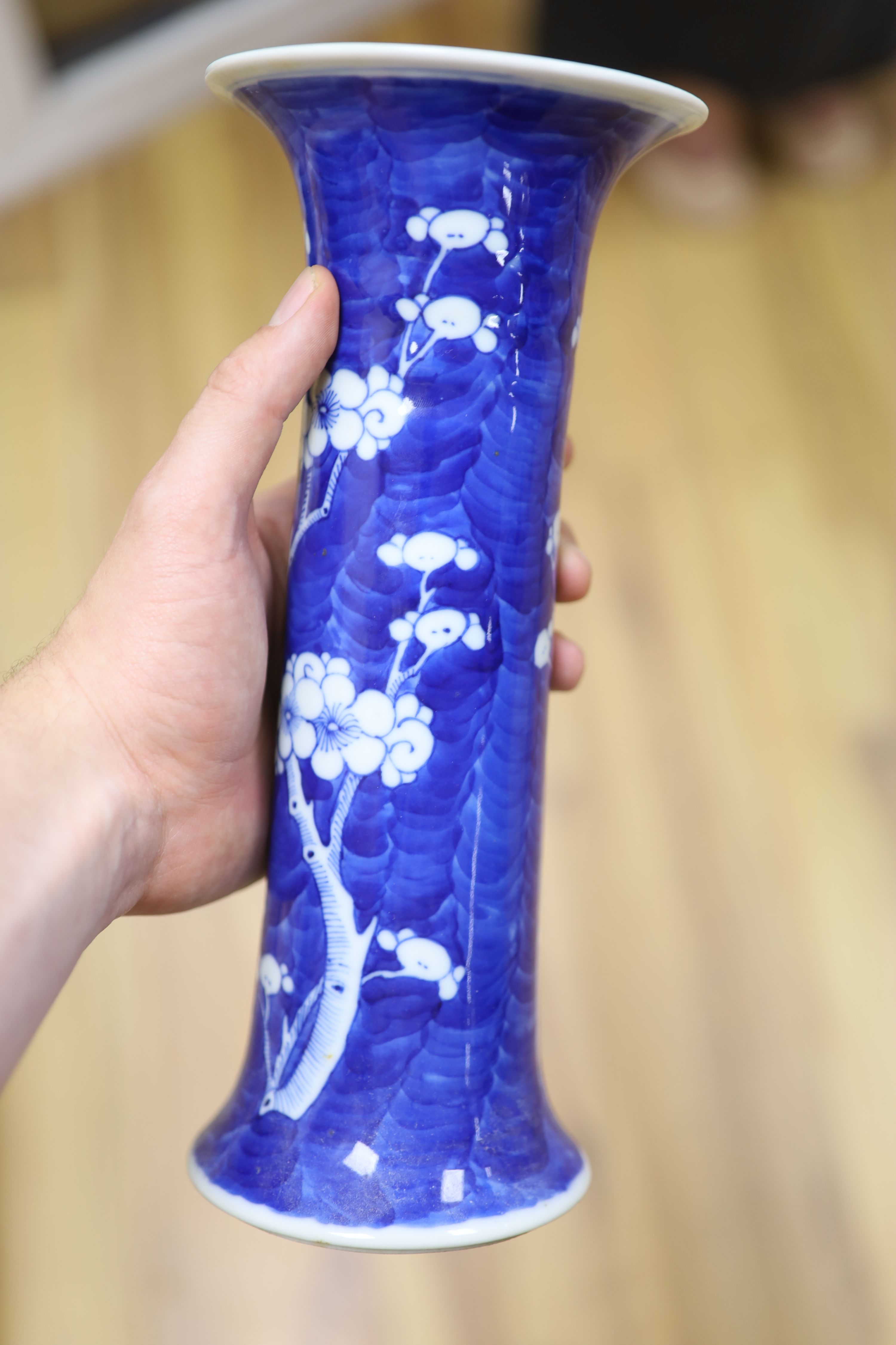 Two Chinese blue and white prunus pattern ginger jars and a similar cylinder vase, tallest 26cm